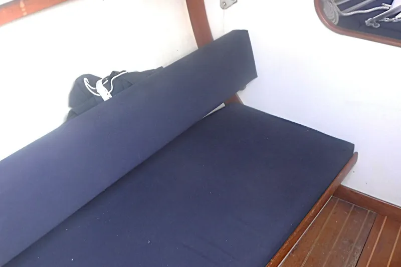Slide: The Image of Interior seating of 1997 Alerion Express 28 sailboat with blue cushions. - 52