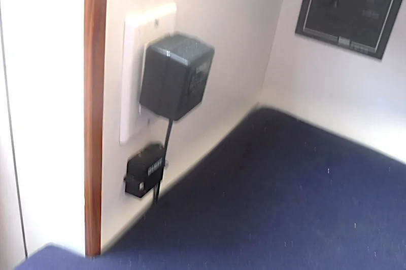 Slide: The Image of Electrical outlet and charger inside a 1997 Alerion Express 28 sailboat cabin. - 30