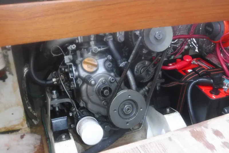Slide: The Image of Engine compartment of a 1997 Alerion Express 28 sailboat, featuring mechanical components and wiring. - 32