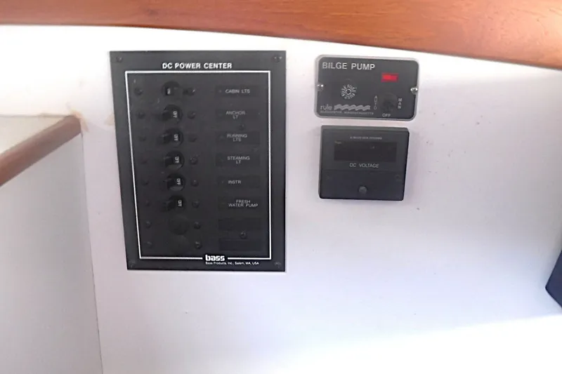 Slide: The Image of Control panel of a 1997 Alerion Express 28 sailboat, featuring DC power center and bilge pump. - 29