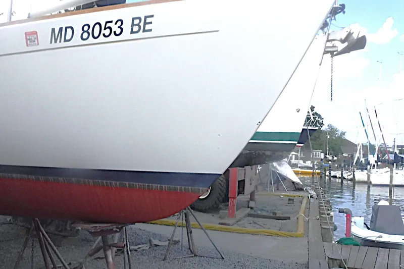 Slide: The Image of Alerion Express 28 sailboat, 1997 model, docked for maintenance at a marina. - 1