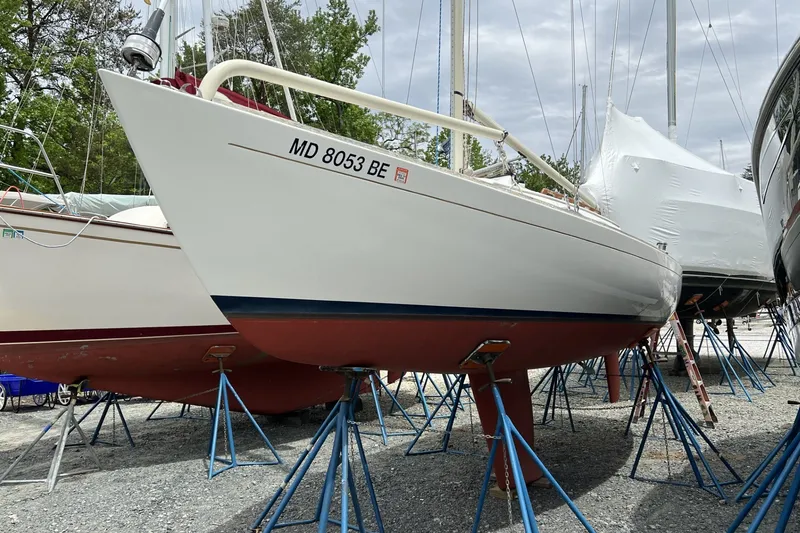 The Image of 1997 Alerion Express 28 sailboat on stands in a boatyard. - 0