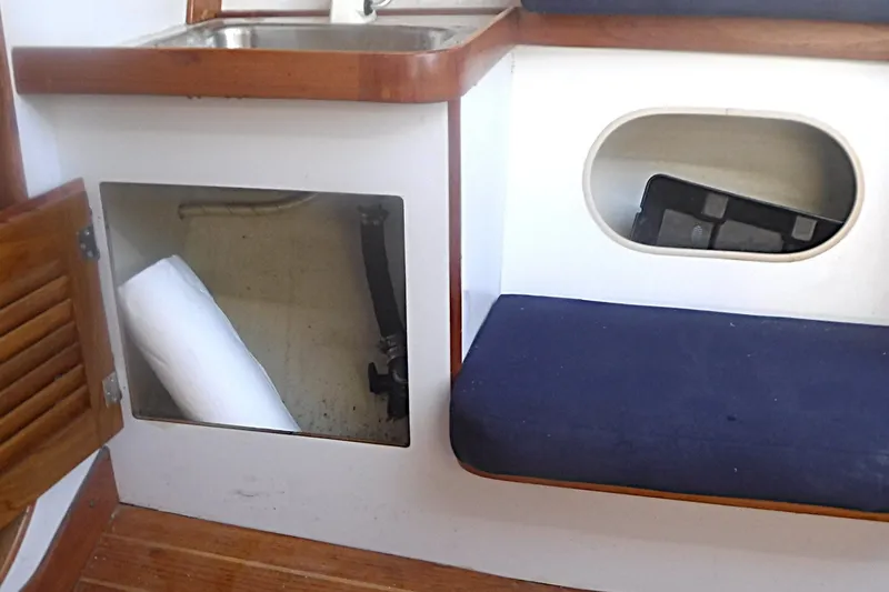 Slide: The Image of Interior of a 1997 Alerion Express 28 sailboat, featuring a sink and storage compartments. - 40