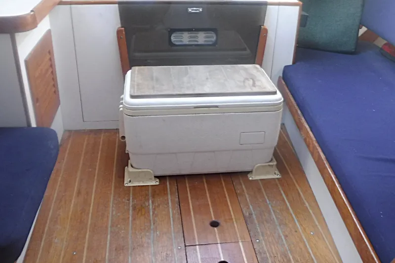 Slide: The Image of Interior of a 1997 Alerion Express 28 sailboat with wooden flooring and seating. - 44