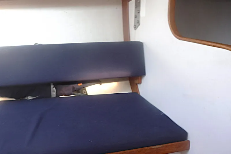 Slide: The Image of Interior seating of a 1997 Alerion Express 28 sailboat with blue cushions. - 42