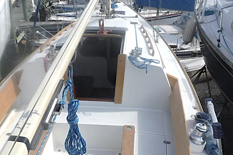 Slide: The Image of 1997 Alerion Express 28 sailboat cockpit with ropes and winches in a marina. - 18