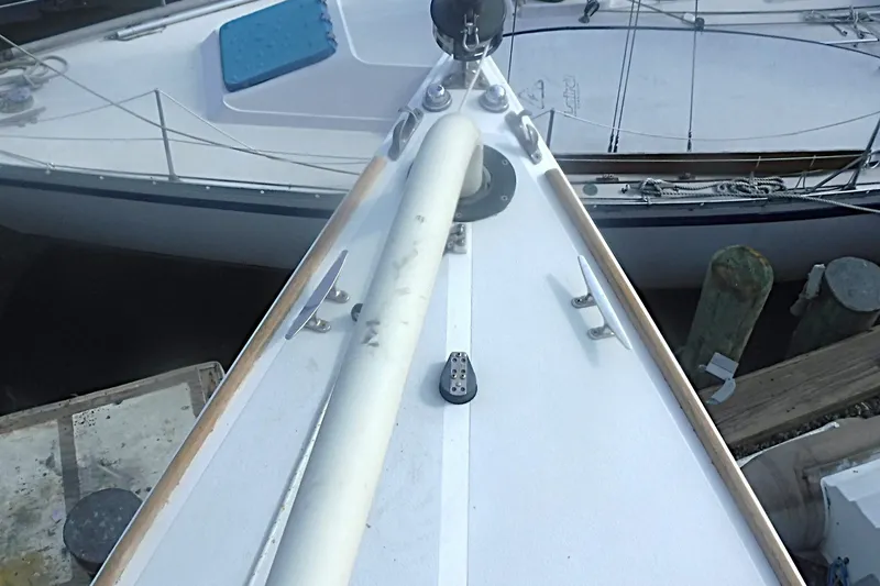 Slide: The Image of Bow view of a 1997 Alerion Express 28 sailboat docked at a marina. - 23