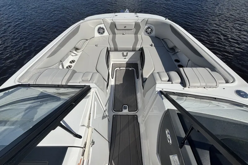 Slide: The Image of 2024 Hurricane SunDeck 2600 OB boat interior with spacious seating and sleek design on the water. - 12