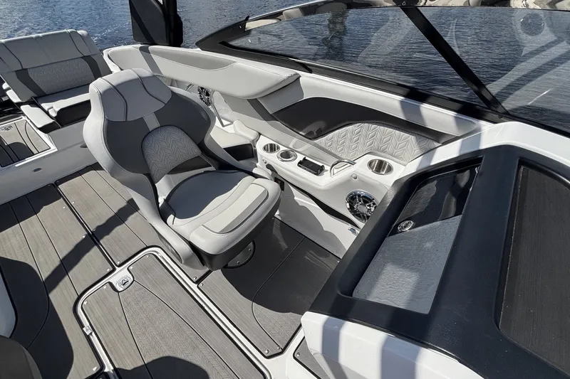 Slide: The Image of 2024 Hurricane SunDeck 2600 OB boat interior with modern seating and sleek dashboard design. - 11