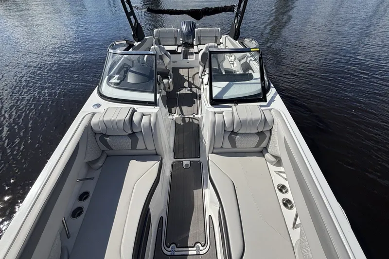 Slide: The Image of 2024 Hurricane SunDeck 2600 OB boat interior with spacious seating and sleek design on water. - 13