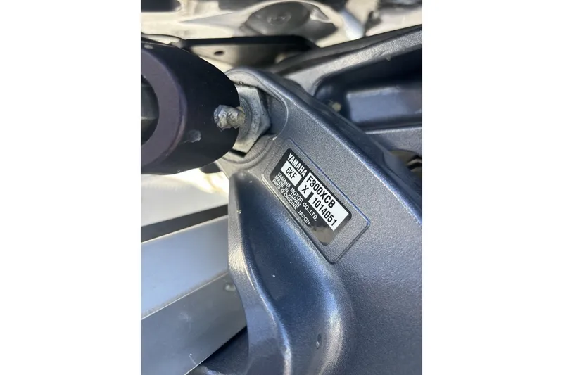 Slide: The Image of Close-up of a Yamaha F300XCB engine part on a 2024 Hurricane SunDeck 2600 OB boat. - 17