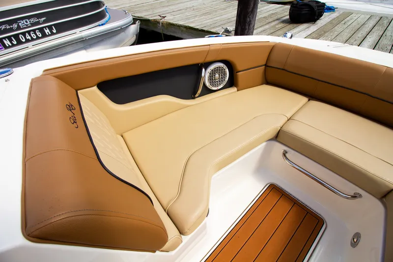 Slide: The Image of The image shows the seating area of a Sea Ray 220 Sundeck boat with beige and brown upholstery. - 48