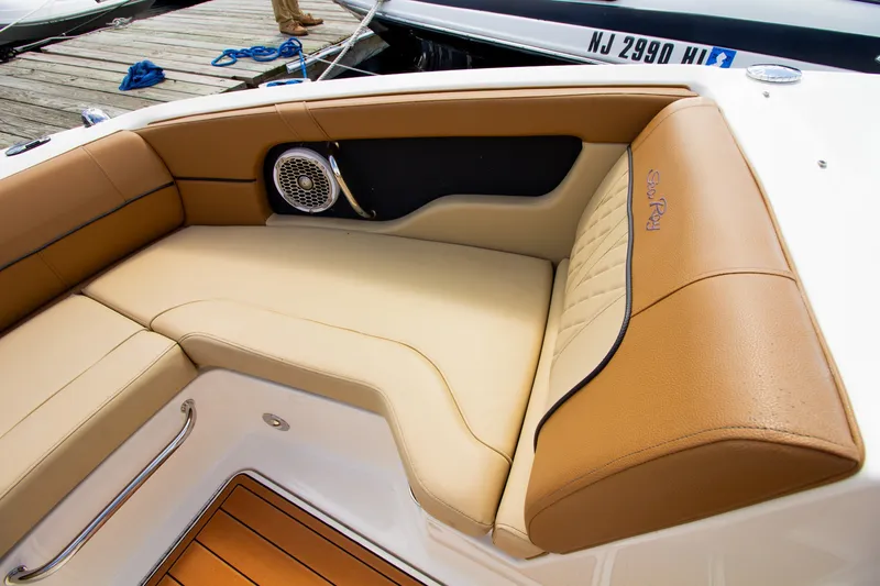 Slide: The Image of The 2015 Sea Ray 220 Sundeck features elegant beige upholstery and a built-in sound system. - 49