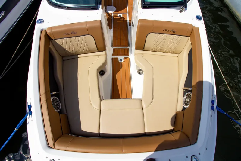 Slide: The Image of The image shows the cockpit of a Sea Ray 220 Sundeck boat with beige upholstery. - 24