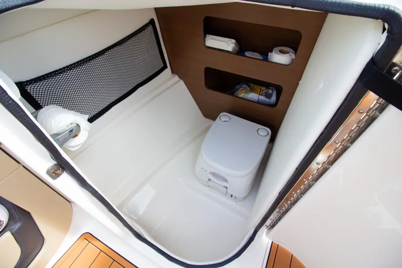 Slide: The Image of The image shows a compact boat toilet with storage space and a small window. - 40