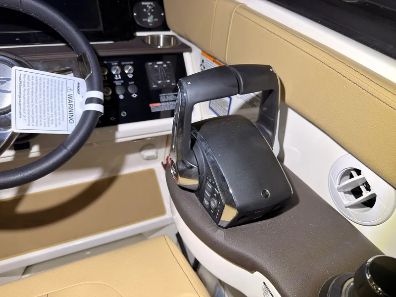 Slide: The Image of The image shows the cockpit of a Sea Ray Sundancer 320 Outboard with modern controls and beige interior. - 22