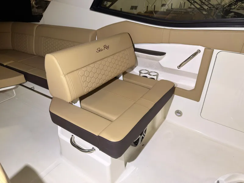 Slide: The Image of The 2026 Sea Ray Sundancer 320 Outboard features luxurious beige upholstery in the seating area. - 25