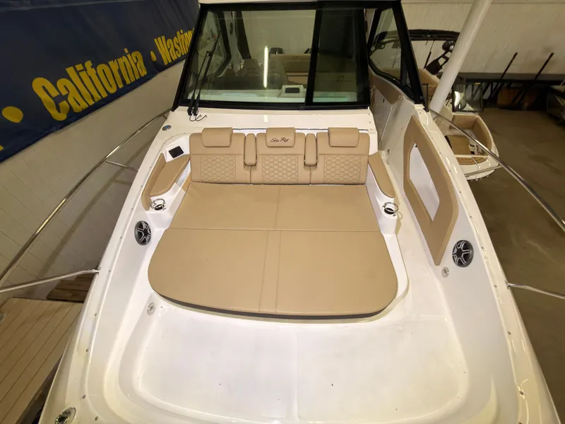 Slide: The Image of The image shows the cockpit of a 2026 Sea Ray Sundancer 320 Outboard with beige upholstery. - 29