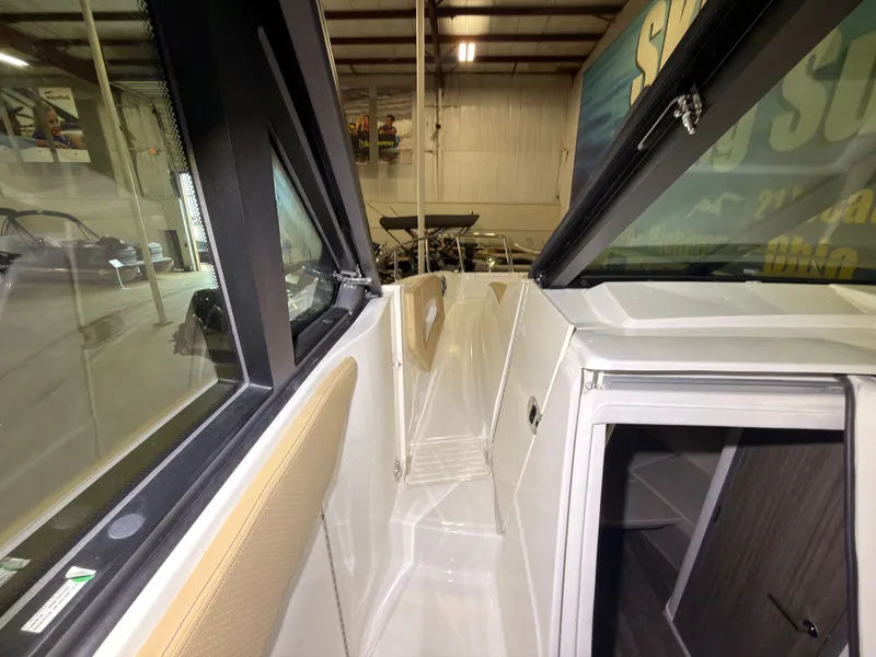 Slide: The Image of Interior view of a 2026 Sea Ray Sundancer 320 Outboard with modern finishes and windows. - 27