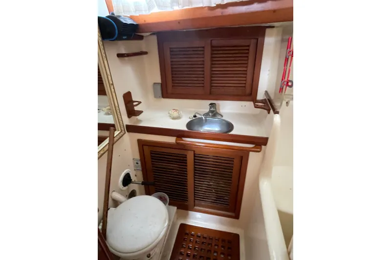 Slide: The Image of Compact bathroom in 1986 Slocum 43 yacht with wooden cabinets and sink. - 45