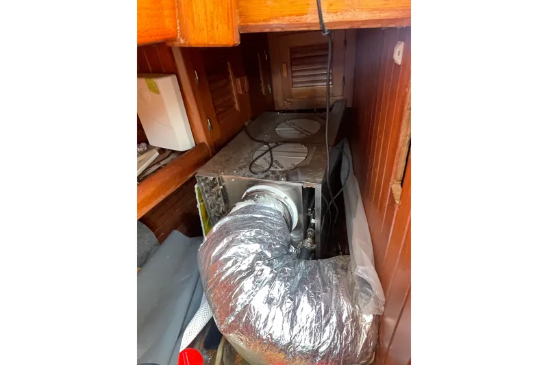 Slide: The Image of 1986 Slocum 43 yacht interior with HVAC ductwork and wooden cabinetry. - 53