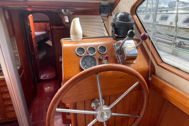 Slide: The Image of Interior helm of 1986 Slocum 43 sailboat with wooden wheel and navigation instruments. - 30