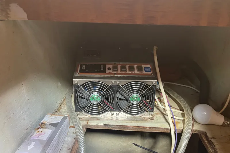 Slide: The Image of Electrical equipment with cooling fans inside a 1986 Slocum 43 boat compartment. - 37
