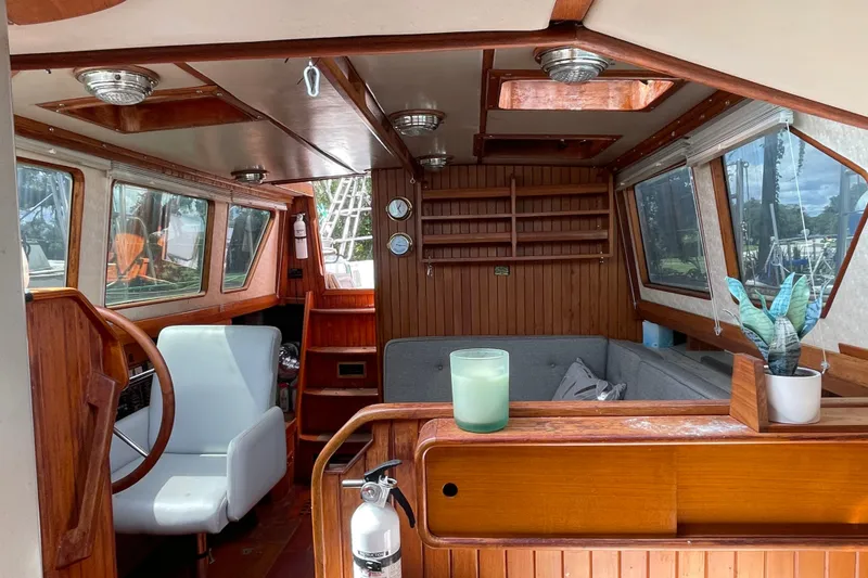Slide: The Image of Interior of a 1986 Slocum 43 yacht with wooden accents and cozy seating area. - 26