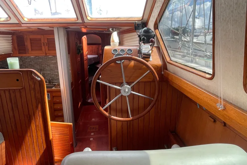Slide: The Image of Interior of a 1986 Slocum 43 sailboat with wooden helm and cozy cabin. - 29