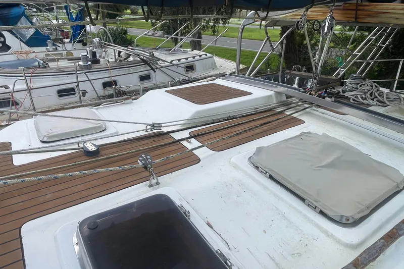 Slide: The Image of Deck of a 1986 Slocum 43 sailboat with wooden accents and rigging details. - 15