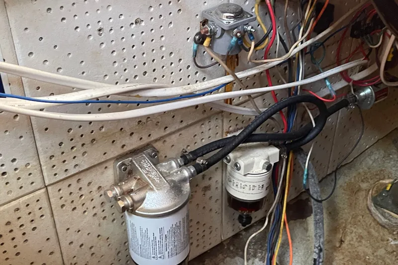 Slide: The Image of Engine compartment wiring and fuel filter system in a 1986 Slocum 43 sailboat. - 47