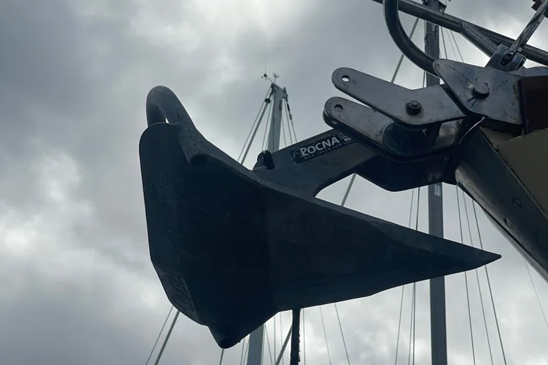 Slide: The Image of Close-up of a Rocna anchor on a 1986 Slocum 43 sailboat under cloudy skies. - 19