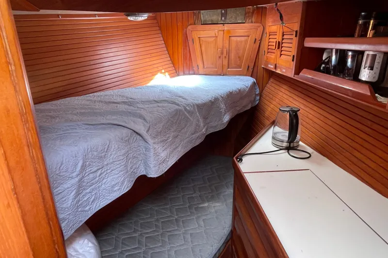 Slide: The Image of Cozy cabin interior of 1986 Slocum 43 sailboat with wooden paneling and bed. - 35