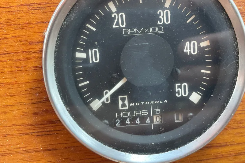 Slide: The Image of Tachometer of a 1986 Slocum 43, showing 2444 hours, on a wooden panel. - 52