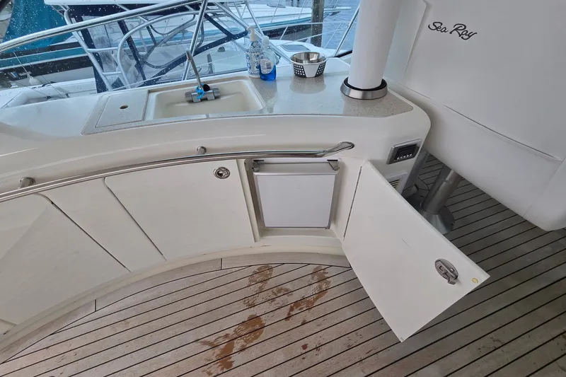 Slide: The Image of 2010 Sea Ray 580 Sundancer yacht kitchen area with sink and open cabinet. - 37