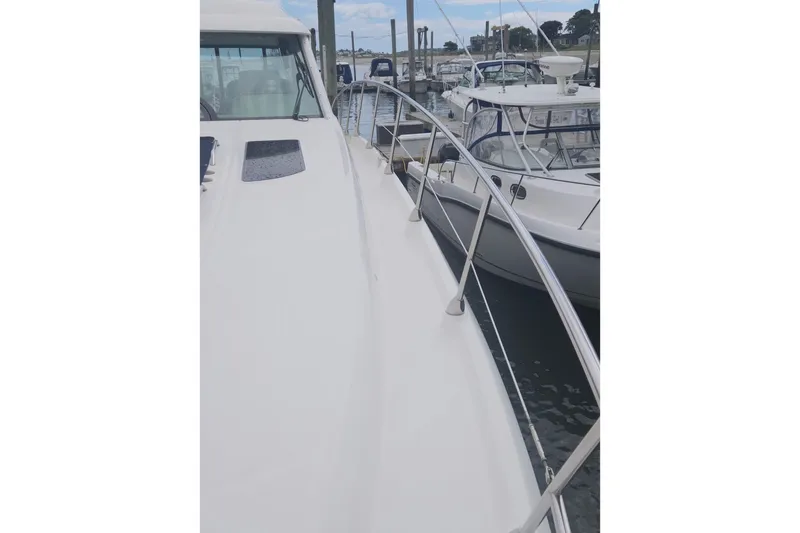 Slide: The Image of 2010 Sea Ray 580 Sundancer yacht docked at marina, side view with railing. - 13