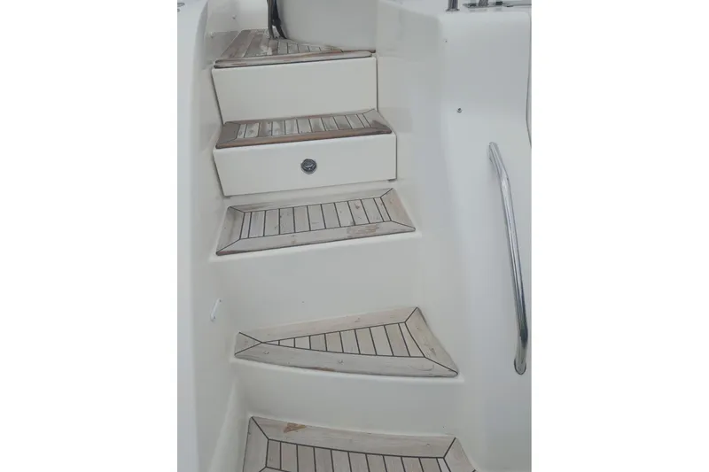 Slide: The Image of Staircase on 2010 Sea Ray 580 Sundancer yacht with wooden steps and metal handrail. - 21