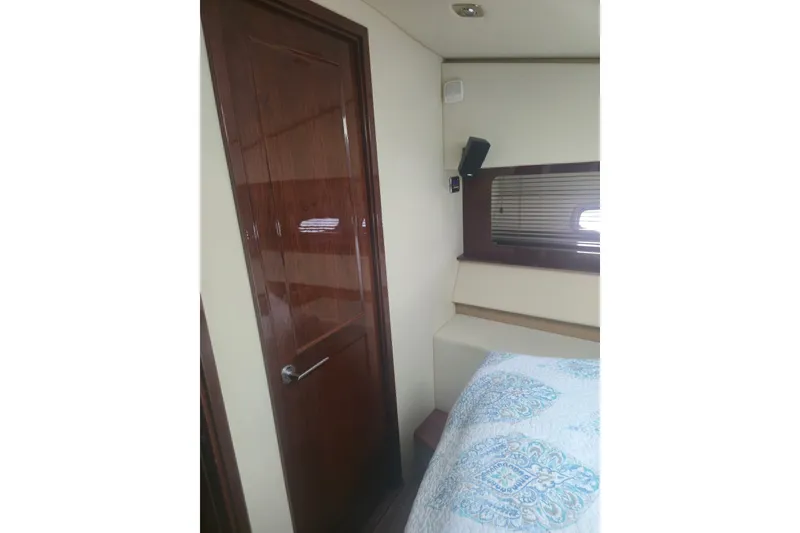 Slide: The Image of Interior cabin of 2010 Sea Ray 580 Sundancer yacht with wooden door and bed. - 57