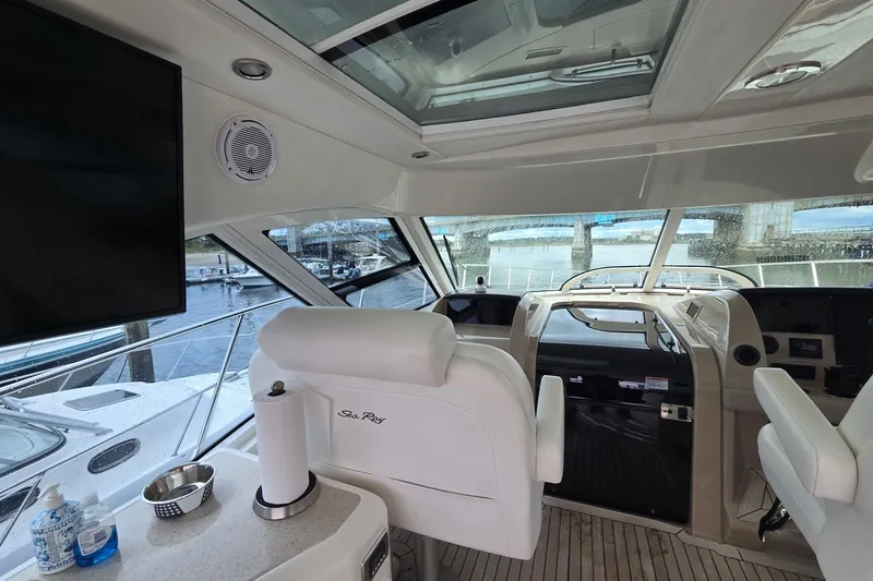 Slide: The Image of Interior view of a 2010 Sea Ray 580 Sundancer yacht cockpit with modern amenities. - 31