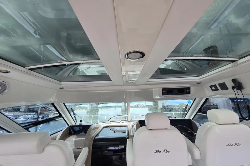 Slide: The Image of Interior view of 2010 Sea Ray 580 Sundancer yacht with glass ceiling and white seating. - 27
