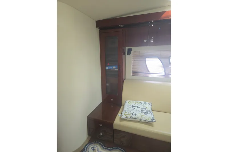 Slide: The Image of Interior of 2010 Sea Ray 580 Sundancer with beige seating and nautical-themed pillow. - 54
