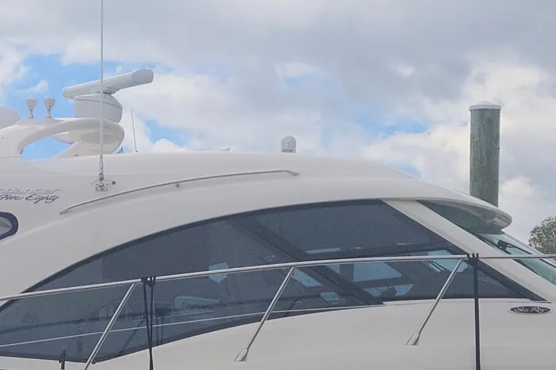 Slide: The Image of 2010 Sea Ray 580 Sundancer yacht with sleek design and modern features against a cloudy sky. - 14