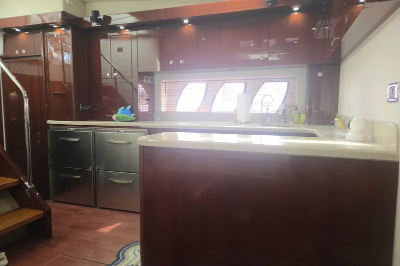 Slide: The Image of Luxurious kitchen interior of 2010 Sea Ray 580 Sundancer yacht with modern cabinetry. - 44