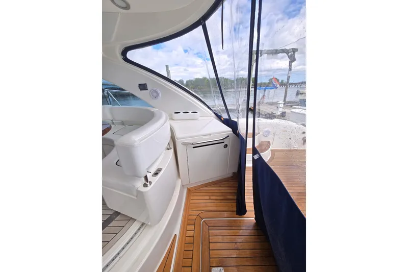 Slide: The Image of Interior view of 2010 Sea Ray 580 Sundancer yacht with white seating and wooden flooring. - 26
