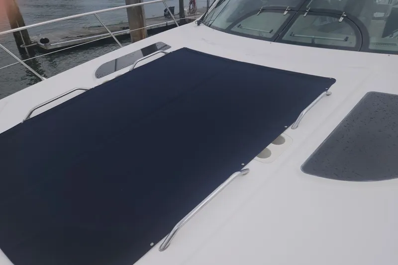 Slide: The Image of 2010 Sea Ray 580 Sundancer yacht with a navy sunshade on deck. - 19