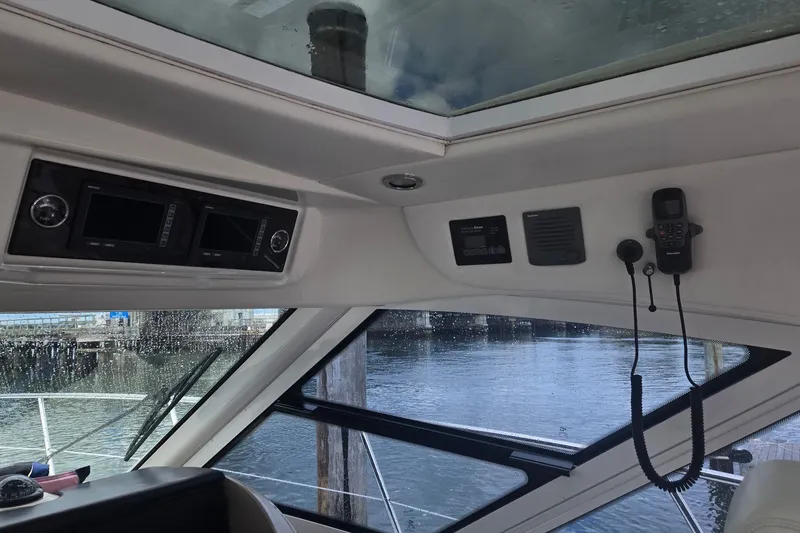 Slide: The Image of Interior view of 2010 Sea Ray 580 Sundancer yacht cockpit with navigation equipment. - 33