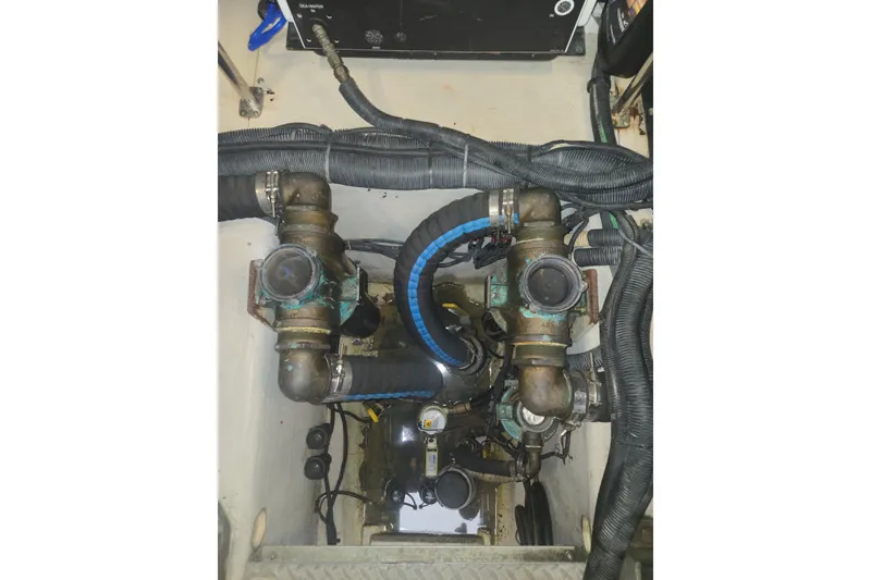 Slide: The Image of Engine compartment of a 2010 Sea Ray 580 Sundancer with visible hoses and fittings. - 66