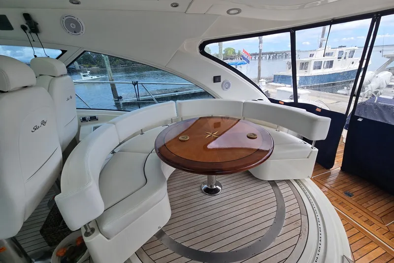 Slide: The Image of Luxurious 2010 Sea Ray 580 Sundancer yacht interior with elegant seating and wooden table. - 28