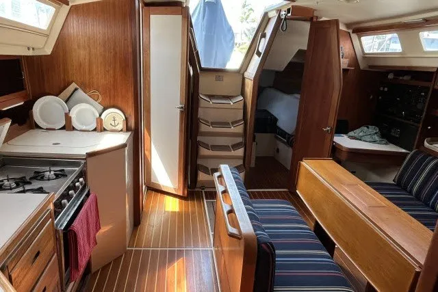 Slide: The Image of Interior of a 1990 Catalina 42 sailboat with wood finishes and cozy seating area. - 2