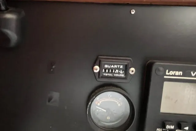 Slide: The Image of Control panel of a 1990 Catalina 42 sailboat with quartz hour meter and Loran navigation system. - 9